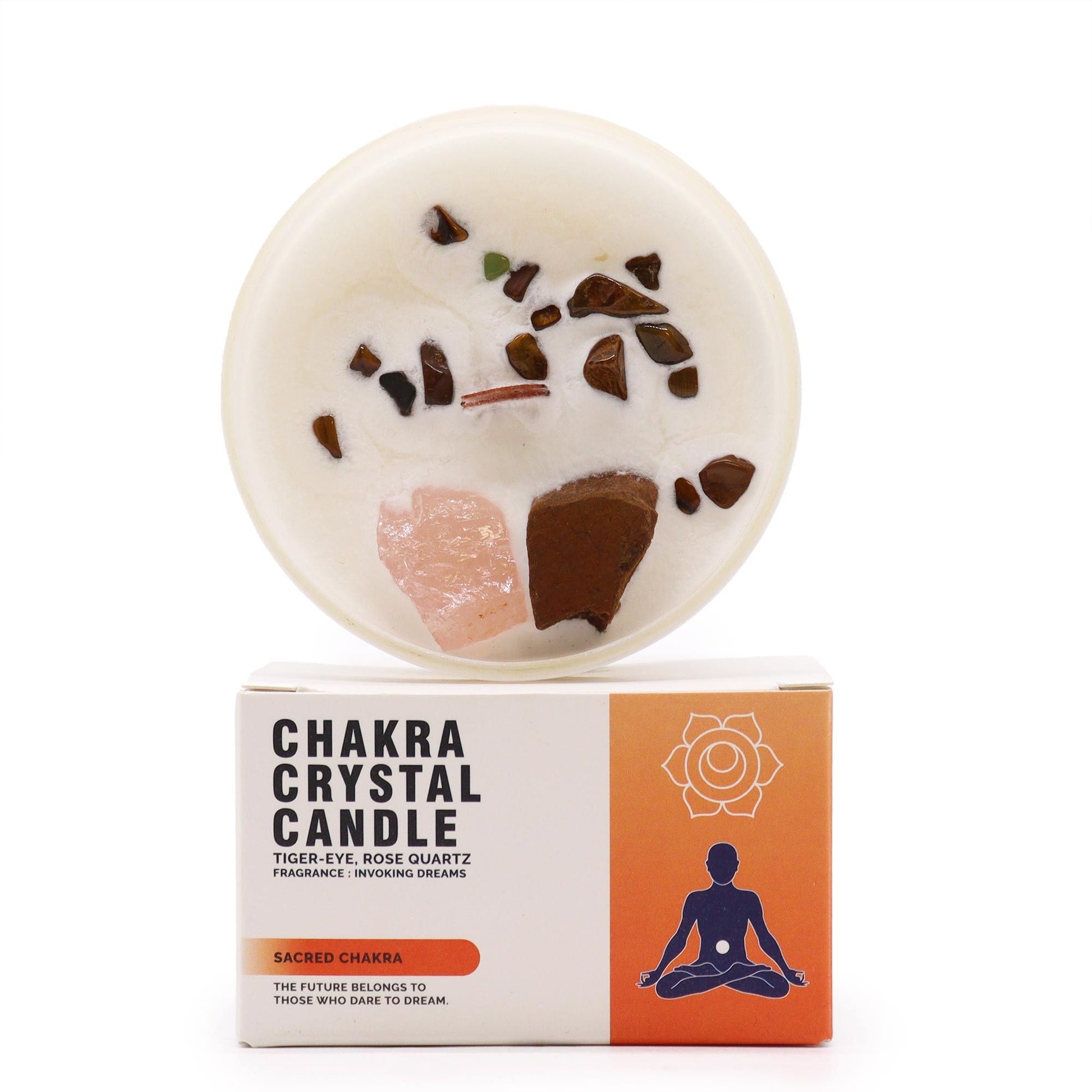 Sacred Sacral Chakra candle topped with orange carnelian crystals and dried flowers, displayed with its ritual packaging.