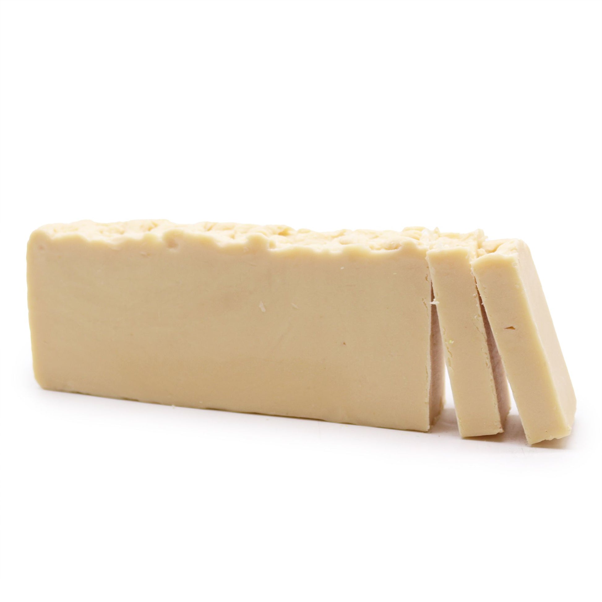 A creamy, off-white artisan soap slice made from donkey milk and olive oil, featuring a smooth, hand-cut texture.