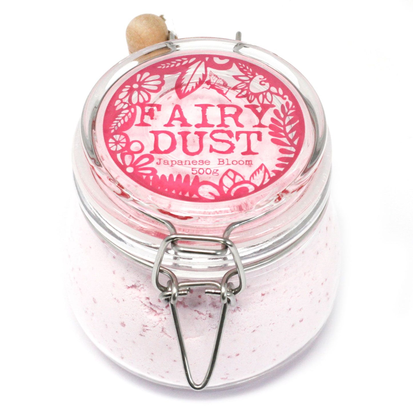 A high-end glass jar filled with 500g of soft pink aromatherapy bath powder and a small wooden measuring spoon.