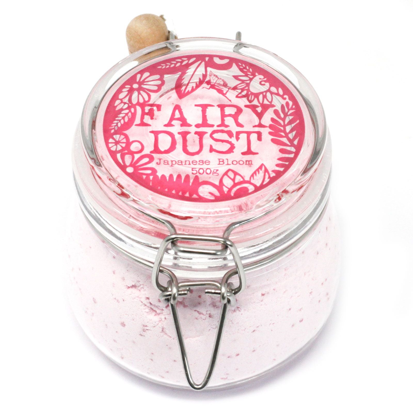 A high-end glass jar filled with 500g of soft pink aromatherapy bath powder and a small wooden measuring spoon.