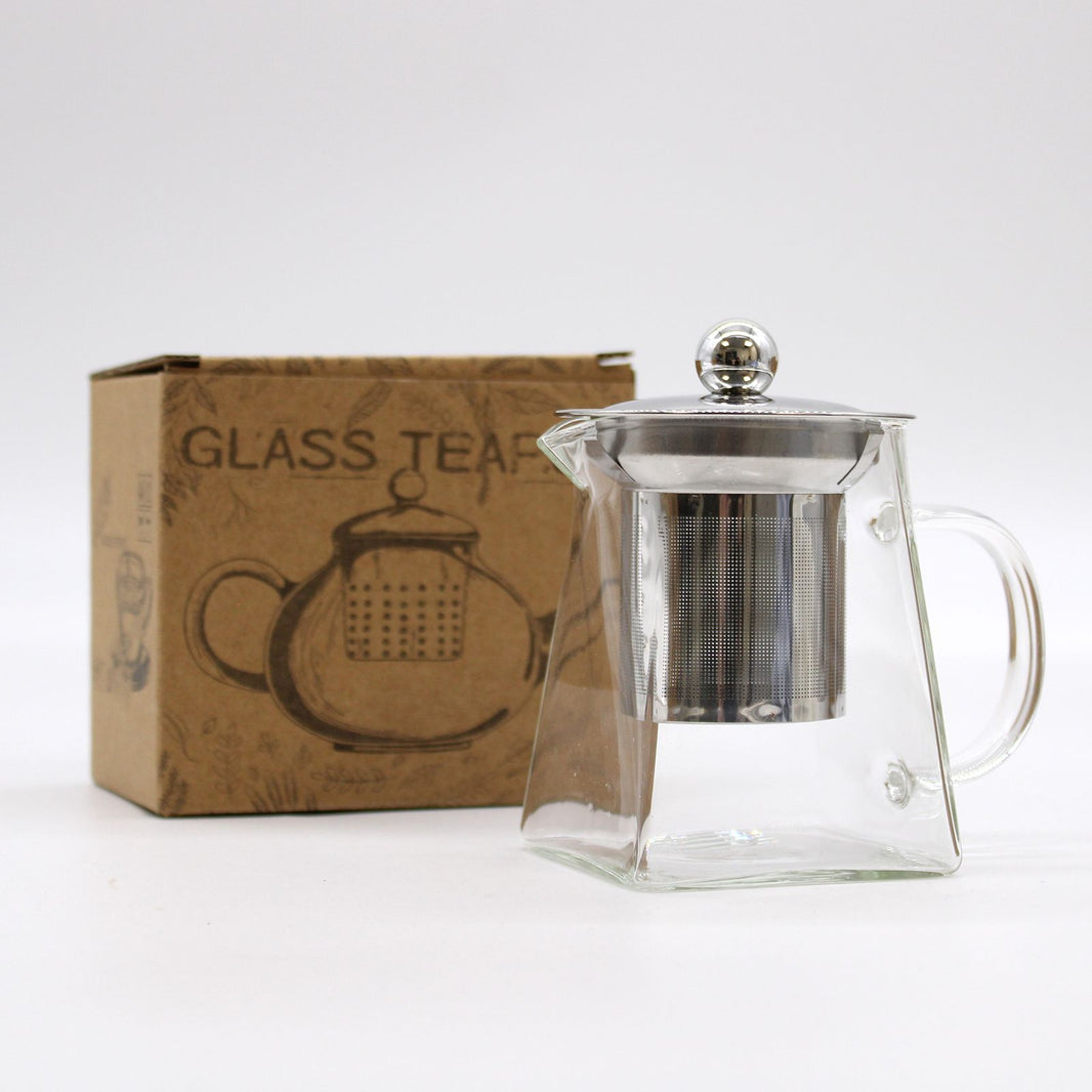 A tall, slender borosilicate glass teapot with a metal infuser and black lid, designed for one person.