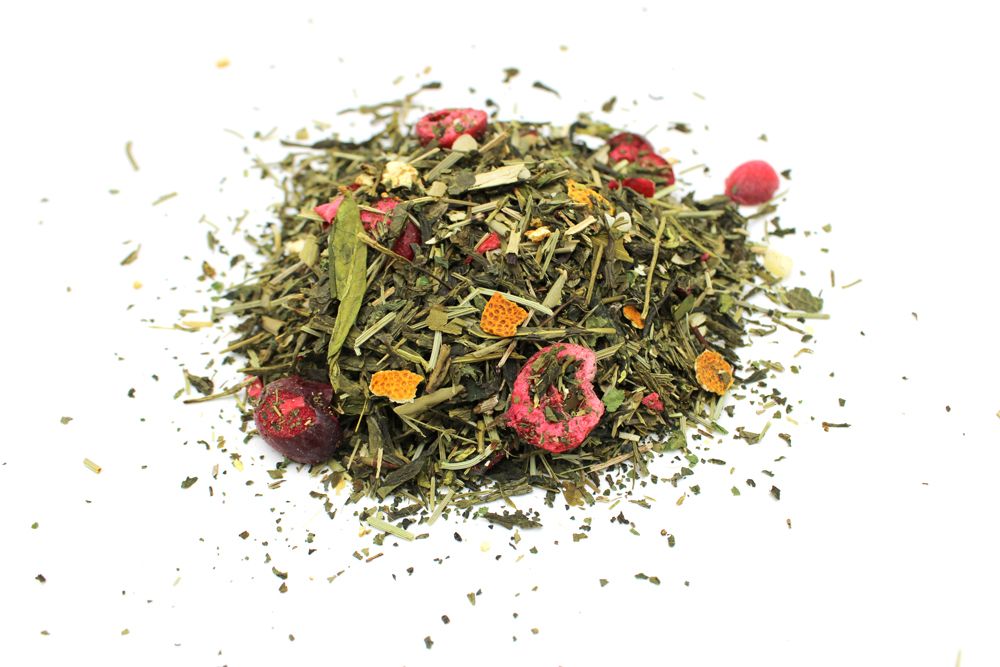 A large bulk quantity of high-quality green loose-leaf tea featuring vibrant whole leaves and light floral inclusions.