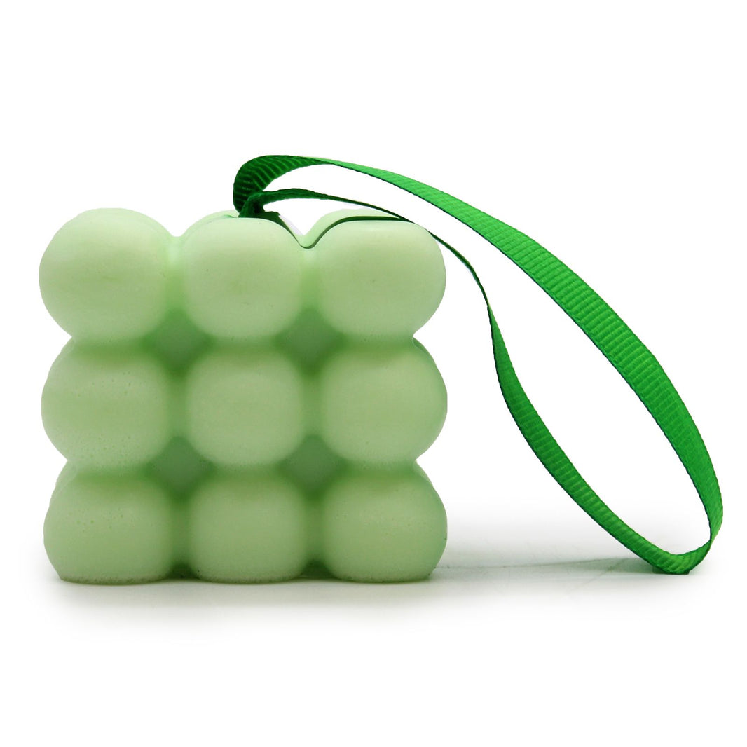 A bright green massage soap bar with a bumpy texture for skin stimulation, featuring a fresh minty scent and hanging rope.