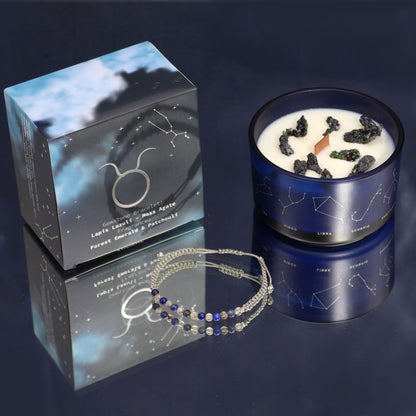 An elegant black Taurus zodiac candle tin with gold foil details and a surprise gemstone bead bracelet.