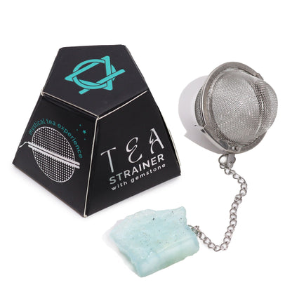 Silver tea infuser ball on a chain with a raw light blue aquamarine crystal charm for calming and peaceful tea rituals.