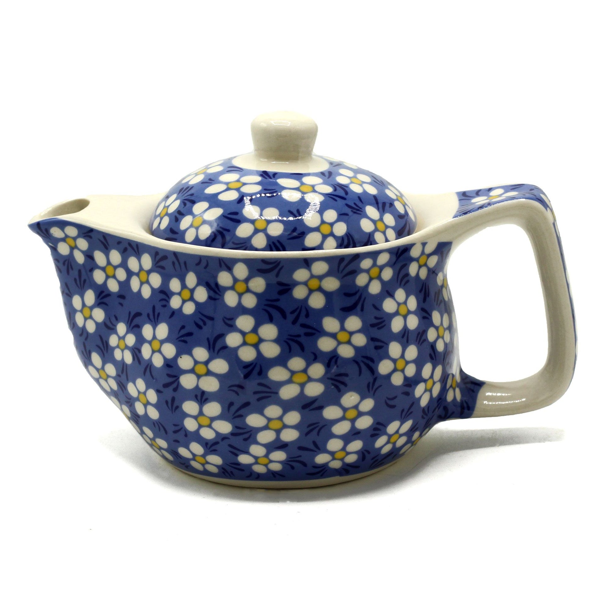 A small white ceramic teapot decorated with a blue background and white daisy flower patterns.