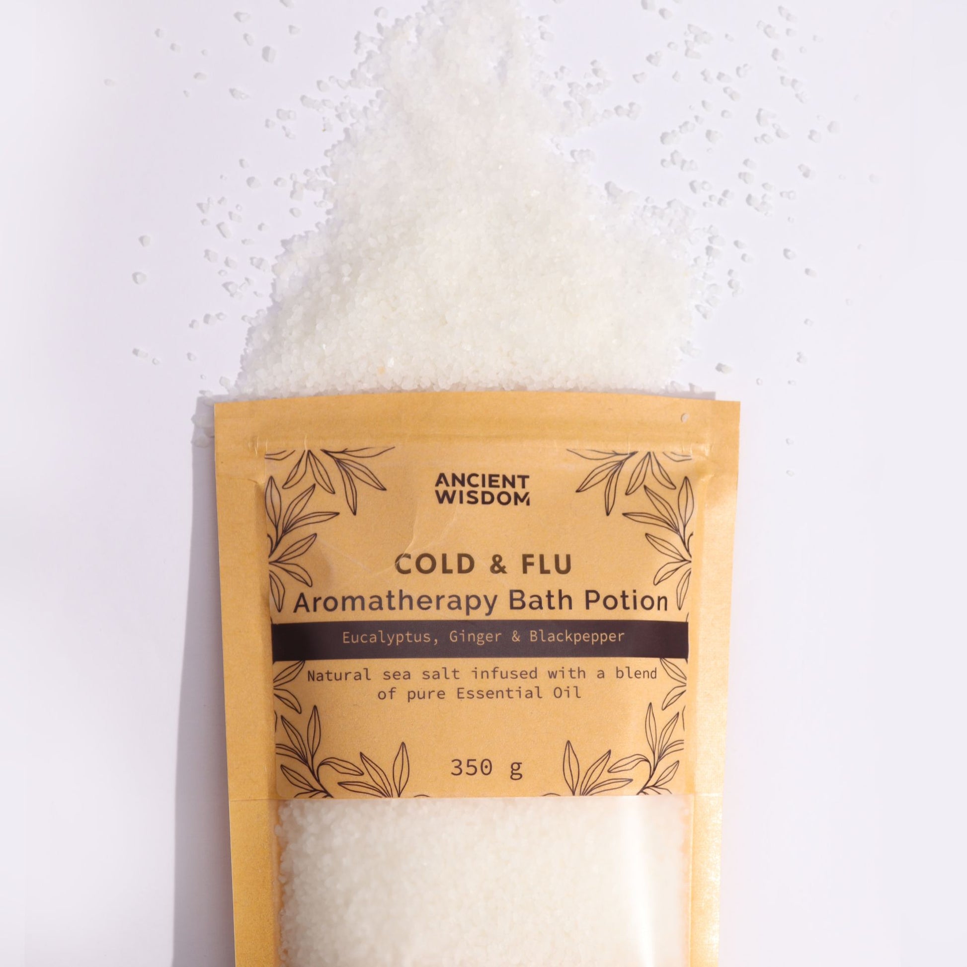A rustic brown kraft paper bag filled with white aromatherapy bath salts infused with therapeutic essential oils for winter wellness.