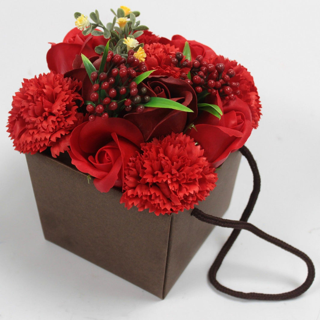 A rich red soap flower bouquet with roses and carnations in a dark brown decorative gift box.