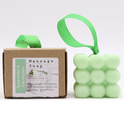 A light green textured massage soap bar with essential oils of Spearmint and Eucalyptus, packaged in a decorative gift box.