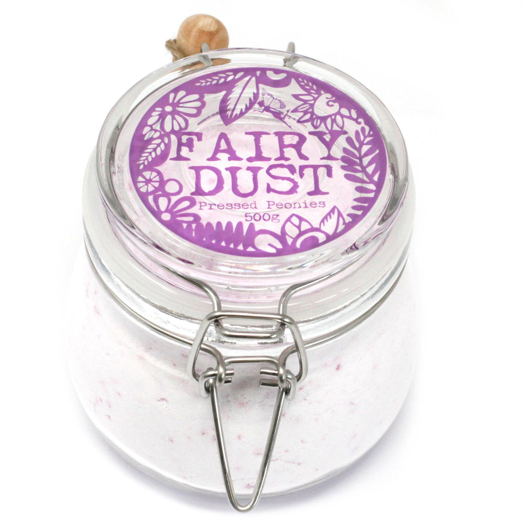 A premium glass jar with a cork lid and wooden scoop containing 500g of light purple-tinted floral bath fizzing dust.