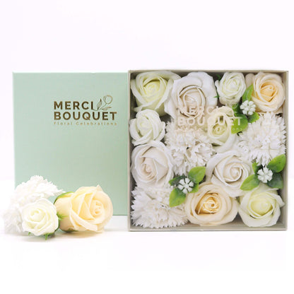 A white square gift box filled with realistic ivory and white soap roses and carnations for wedding celebrations.