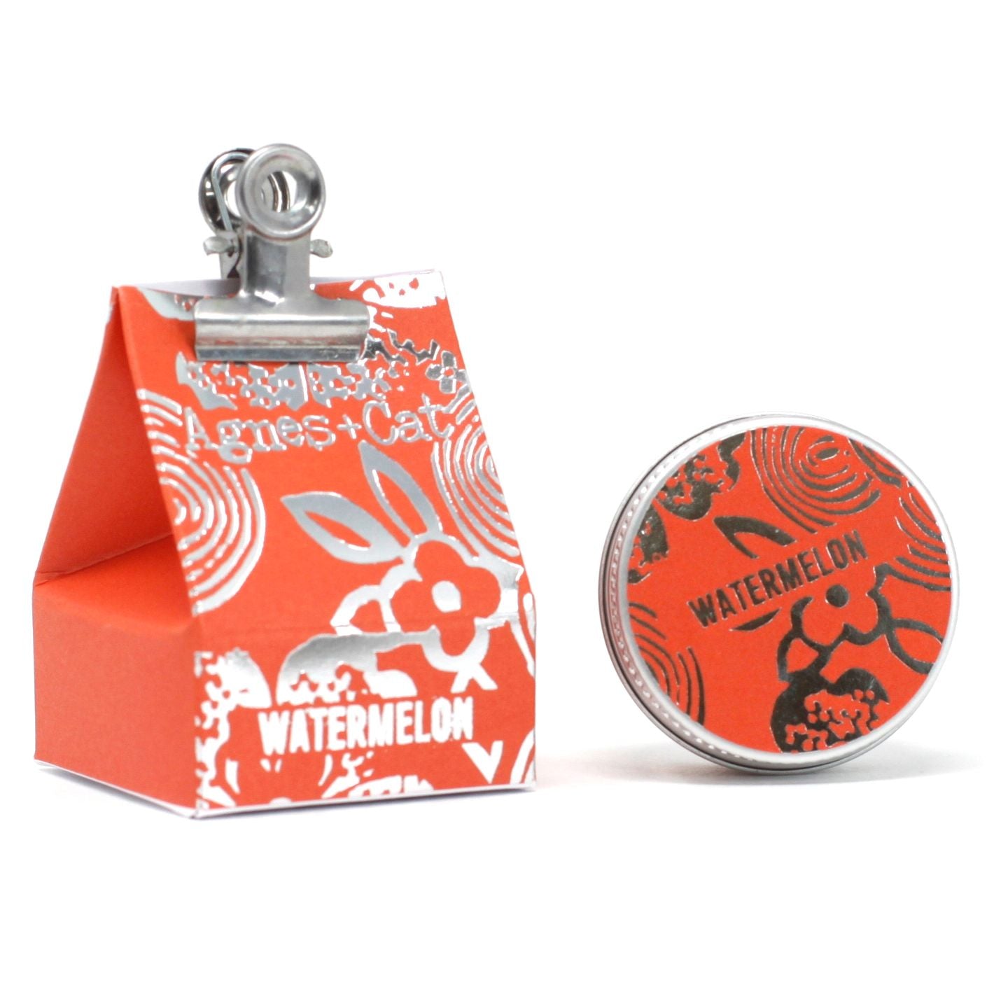 A 20g round tin of pink watermelon-scented lip balm shown with its decorative red watermelon-themed packaging.