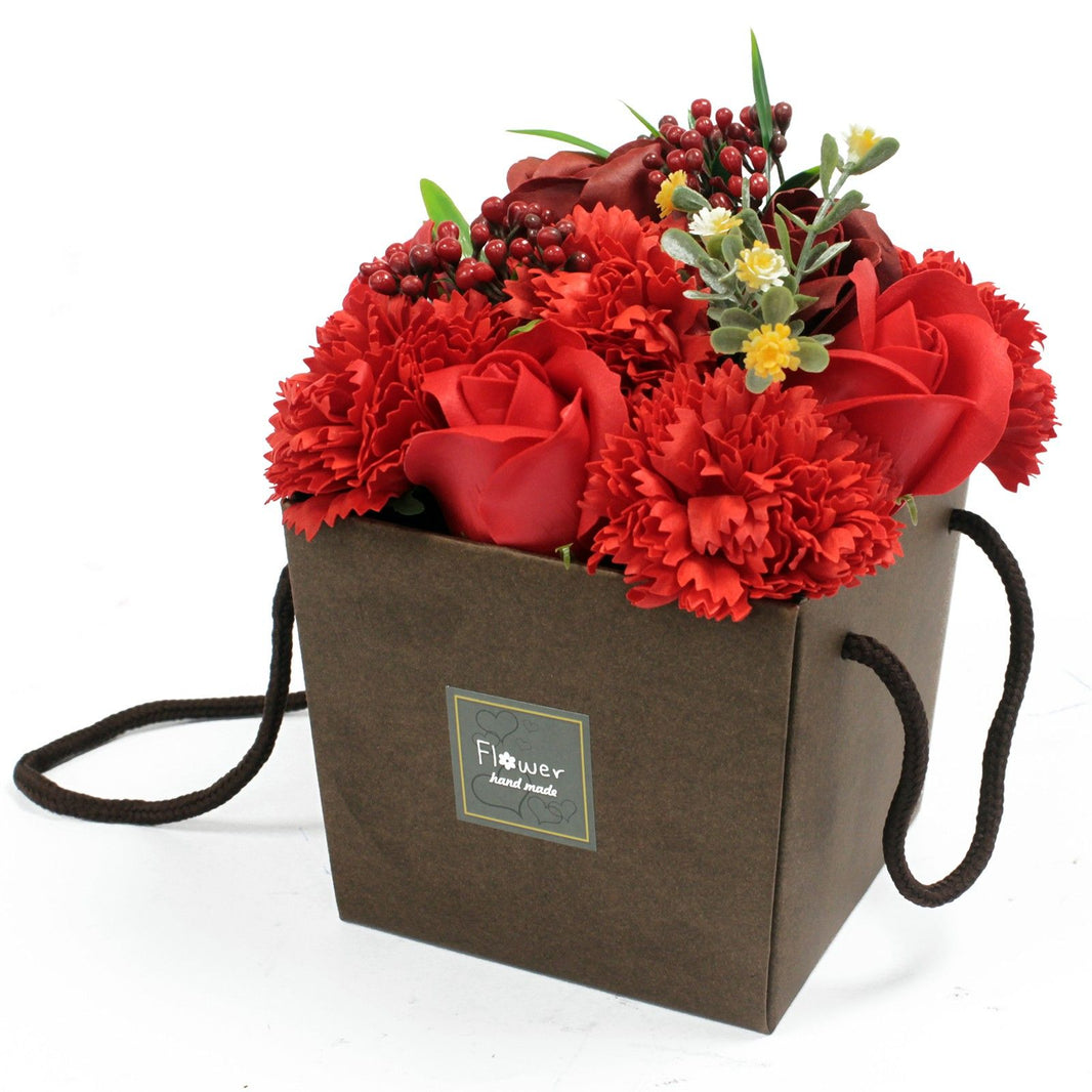 A rich red soap flower bouquet with roses and carnations in a dark brown decorative gift box.