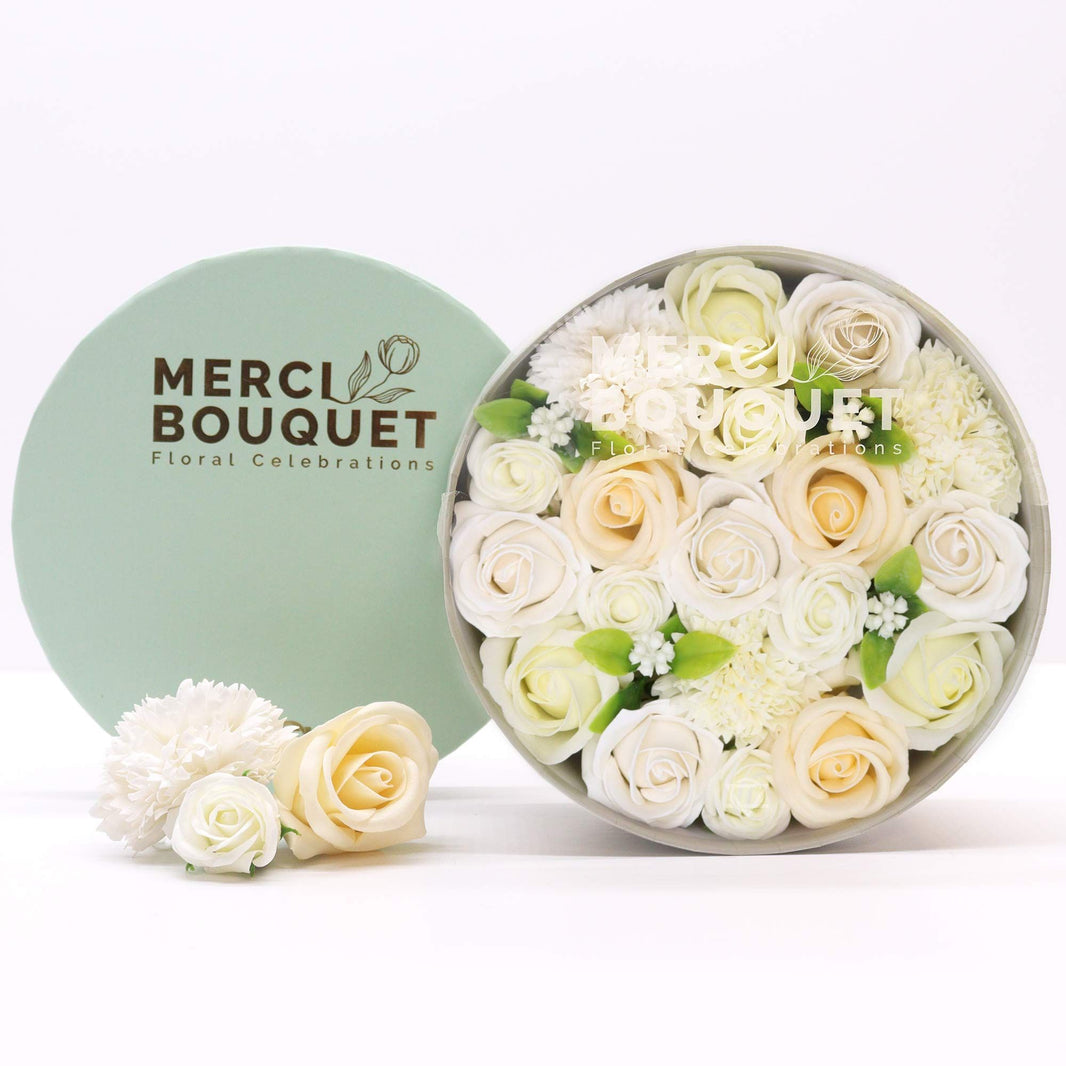 Large round gift box filled with realistic ivory and white soap roses and carnations for wedding celebrations.