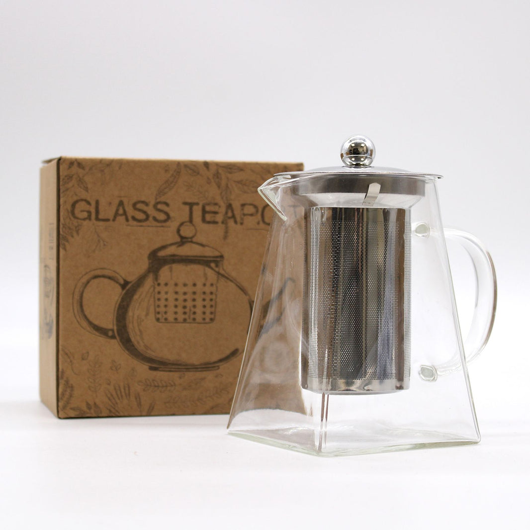 A tall, cylindrical borosilicate glass teapot with a stainless steel infuser and a minimalist black lid.