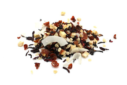 A vibrant 1kg bulk tea blend featuring large pieces of dried exotic fruits, flower petals, and herbal leaves.