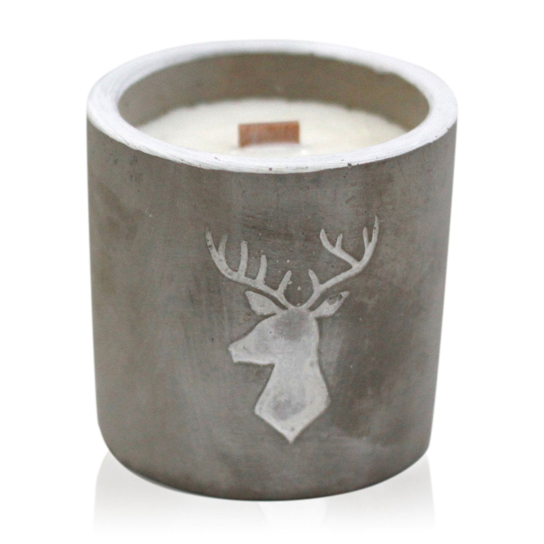 A medium-sized cylindrical grey concrete candle featuring an embossed stag head design on the front.