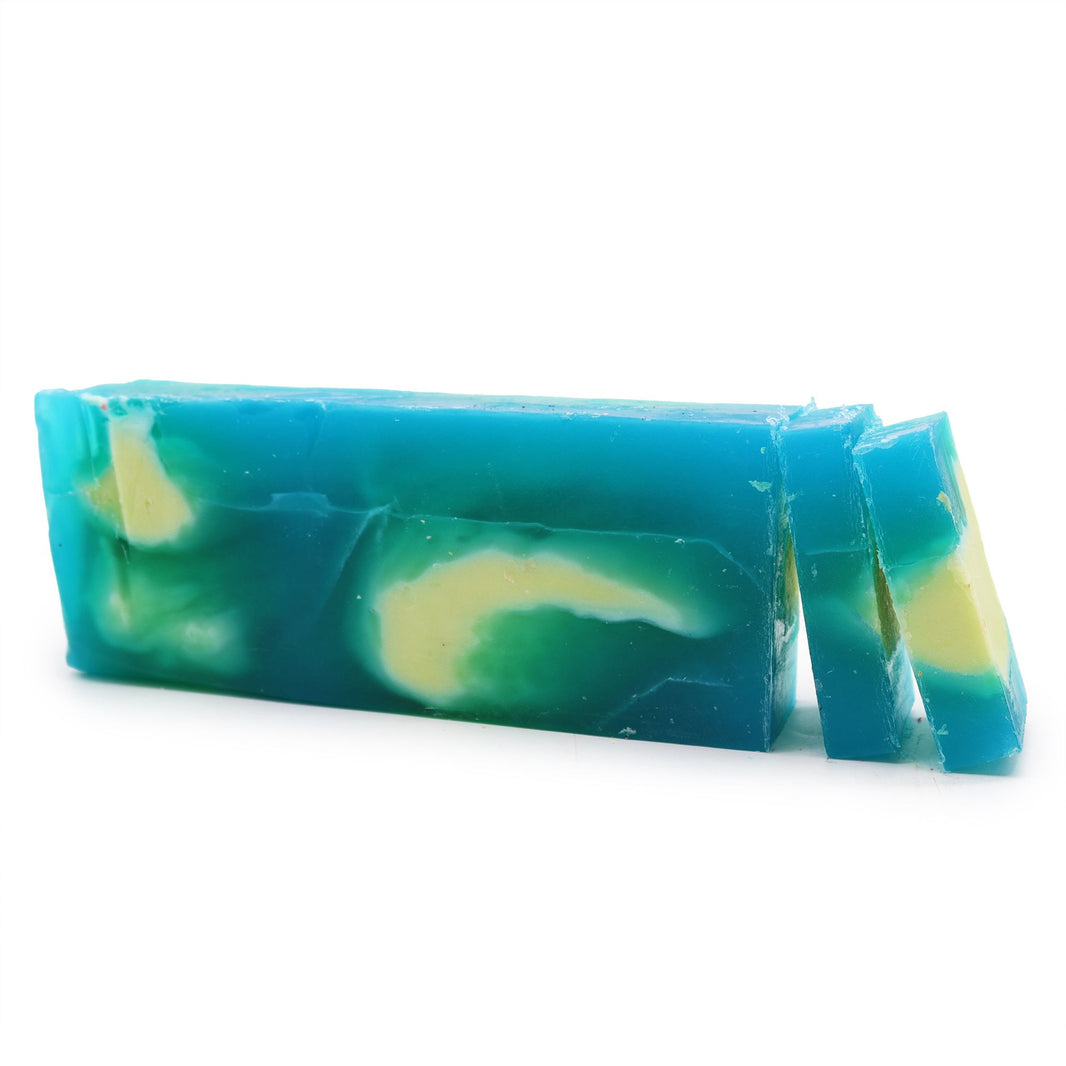 A large 1.25kg handcrafted soap loaf with green and blue botanical swirls and a fresh, herbal rosemary scent.