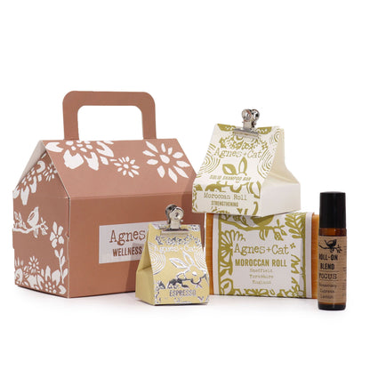 A beautiful cardboard gift box containing a Moroccan Morning candle, soap bar, and bath salts in a cohesive gift presentation.