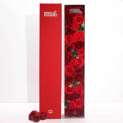 A tall, slender red gift box decorated with classic rose illustrations, containing rose-scented bath salts and soaps.