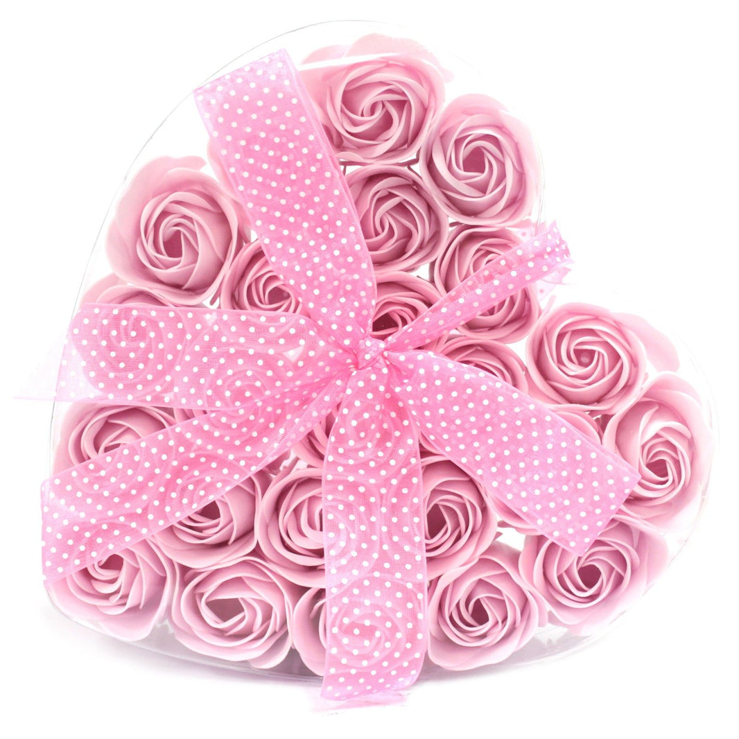 A large heart-shaped pink gift box filled with twenty-four realistic pink soap rose blooms for a romantic ritual.