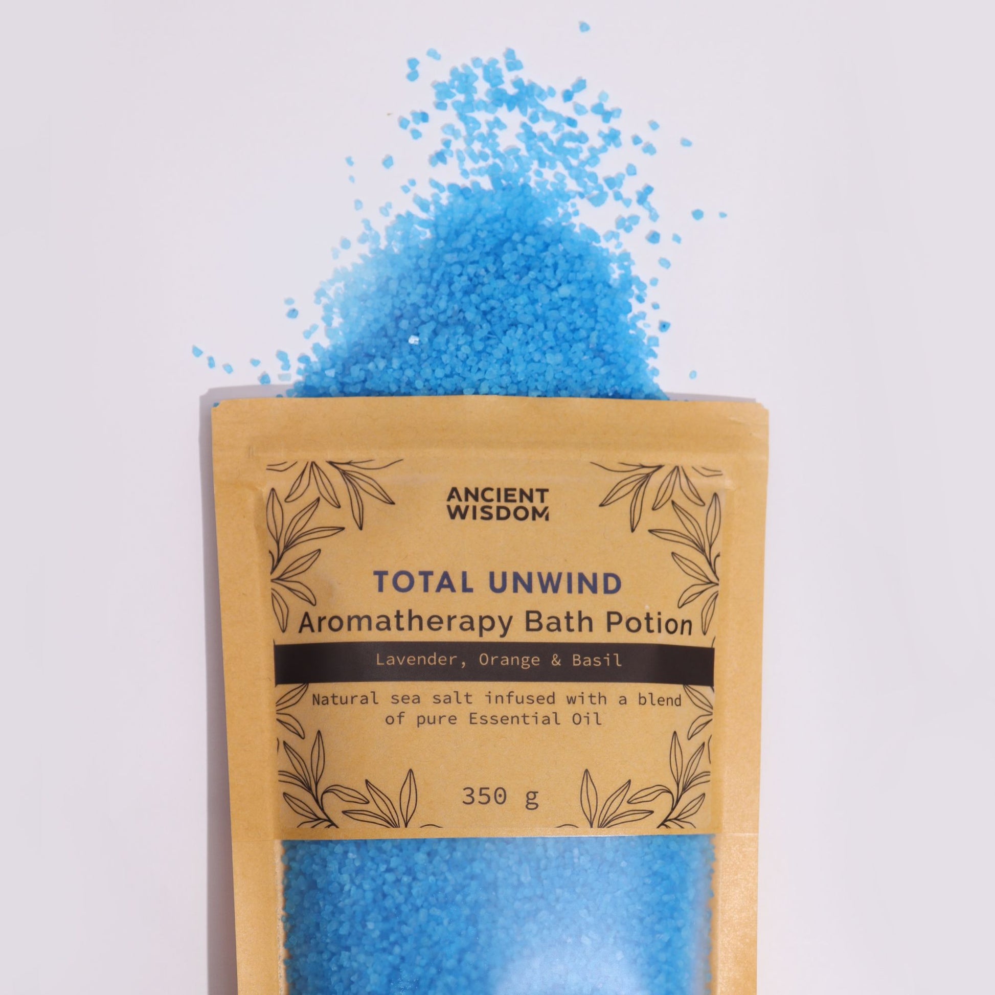 A kraft paper pouch filled with deep blue aromatherapy bath salts designed for total relaxation and muscle stress relief.