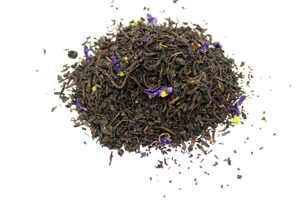 A large quantity of high-quality loose leaf black tea leaves infused with vibrant blue cornflowers and bergamot.