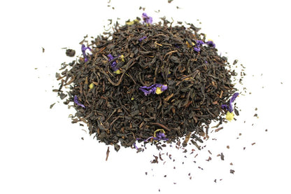 A large quantity of high-quality loose leaf black tea leaves infused with vibrant blue cornflowers and bergamot.
