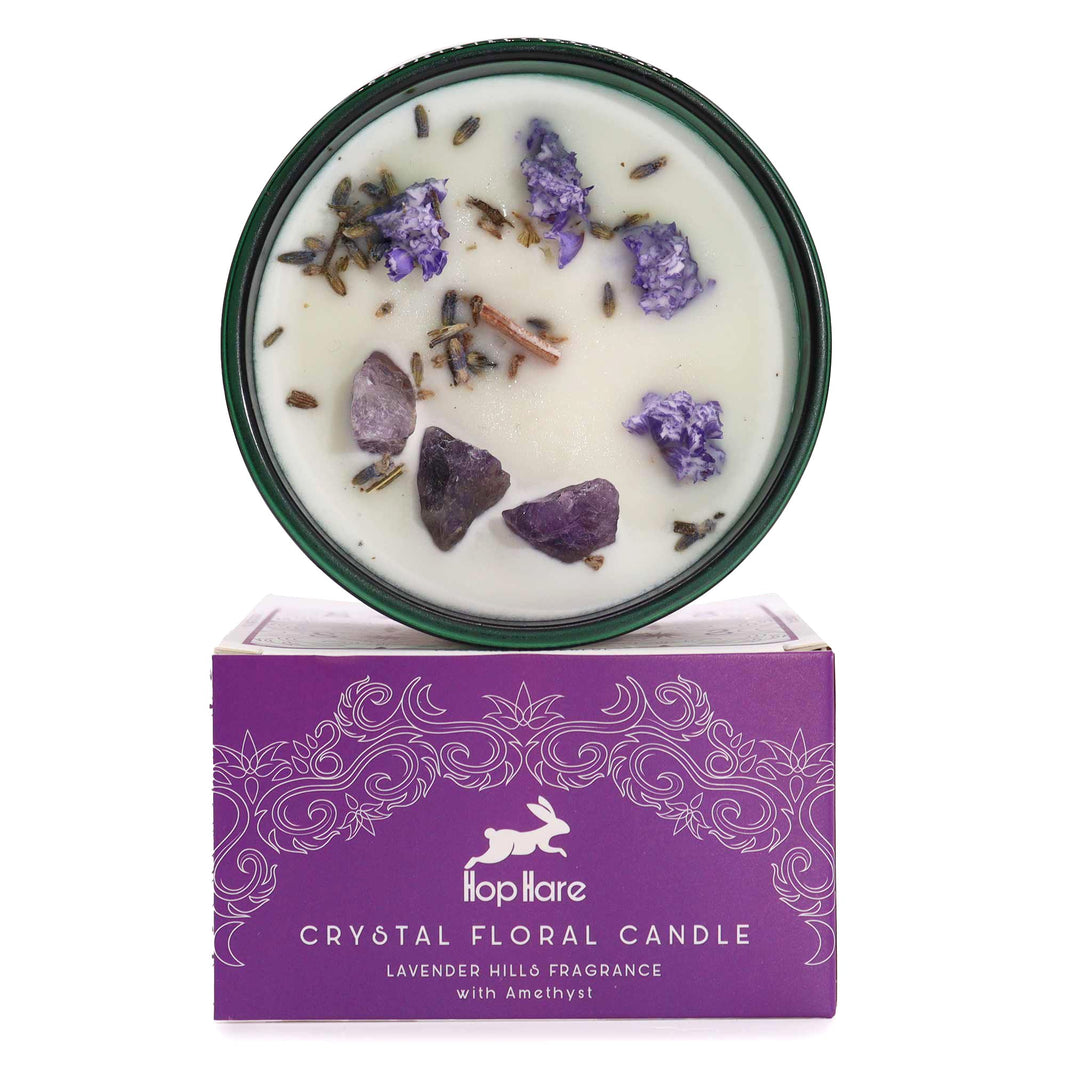 Hop Hare tarot-themed ritual candle in a purple glass jar with embedded healing crystals and dried botanical petals.