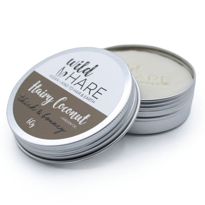 A 60g Wild Hare solid shampoo bar with a coconut scent, presented in a metal travel-friendly storage tin.