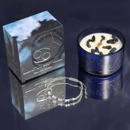 A luxury Cancer-themed candle in dark, elegant packaging with a surprise semi-precious stone bracelet reveal.