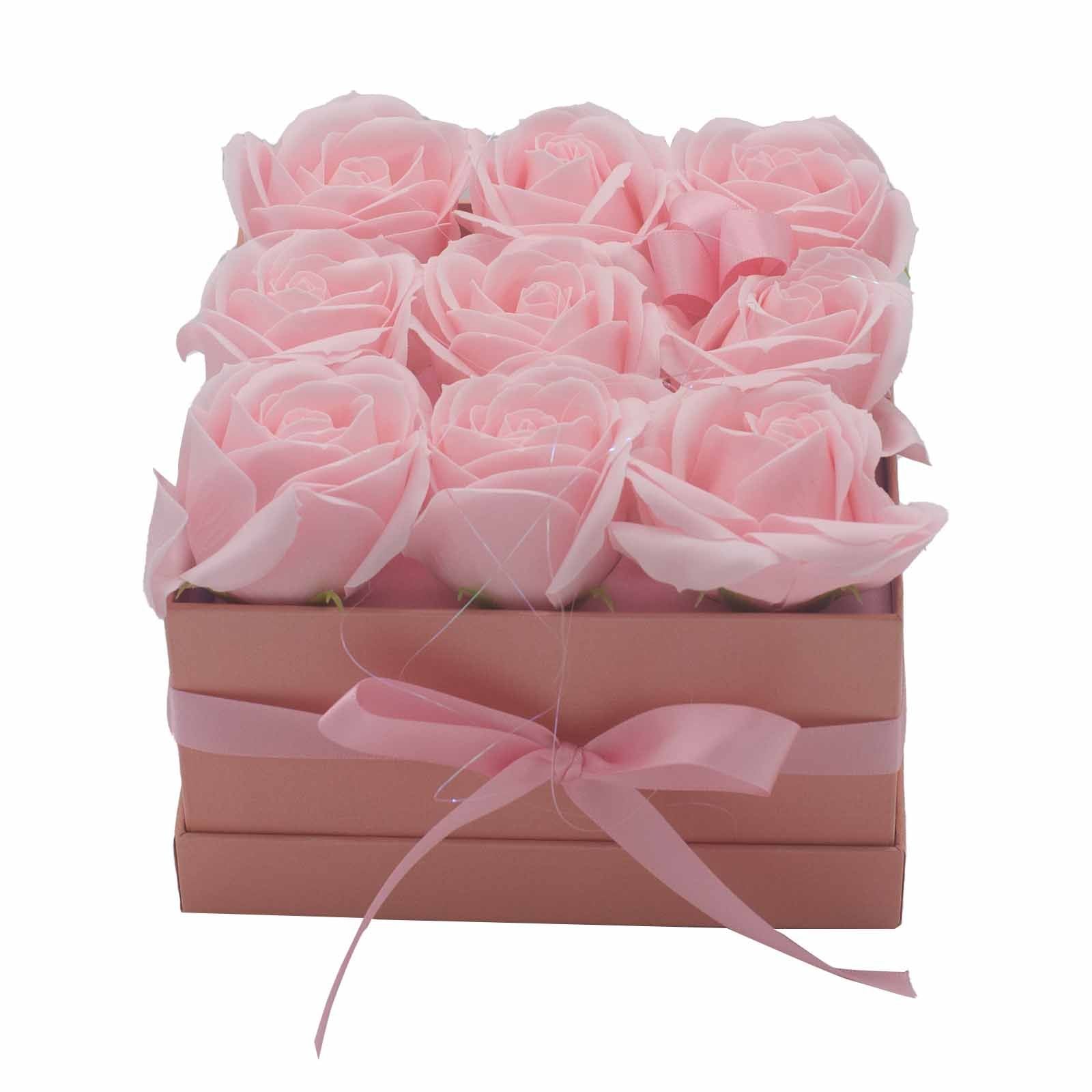 An elegant square gift box containing 9 realistic pink soap rose flowers for a luxury bath soak.