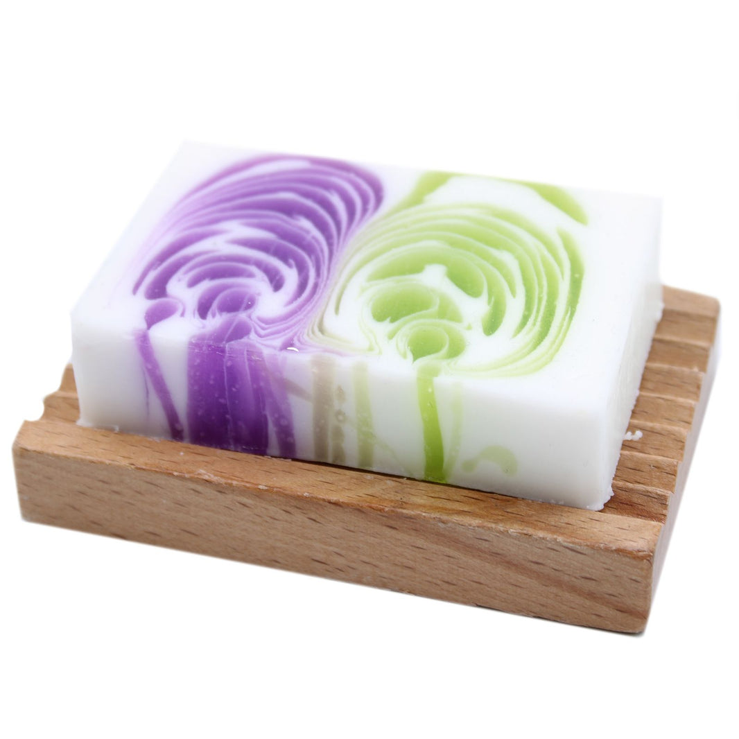A 115g artisan soap slice featuring vibrant purple and green swirls with a sweet dewberry fragrance.