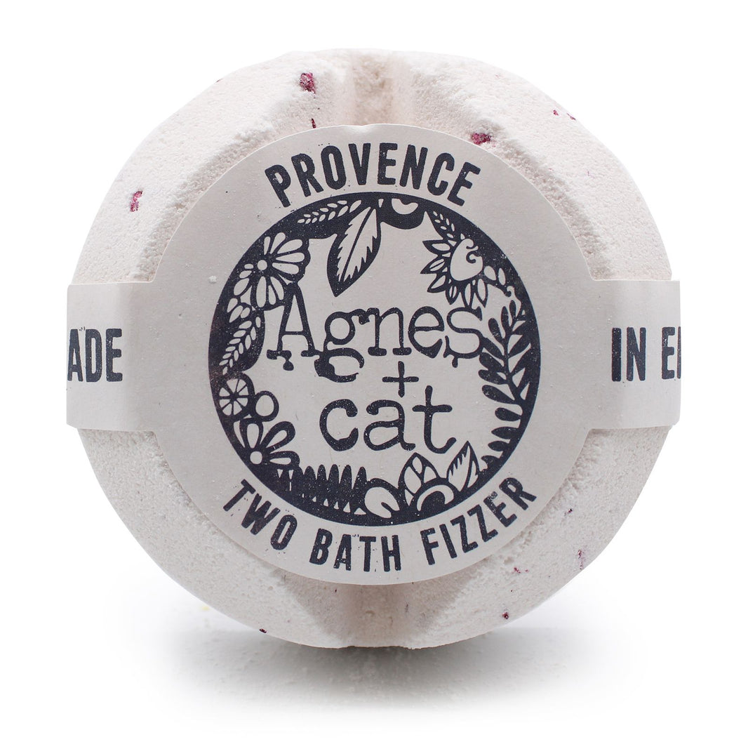 A large white bath fizzer wrapped in plastic with a grey and black label inspired by Provencal lavender.