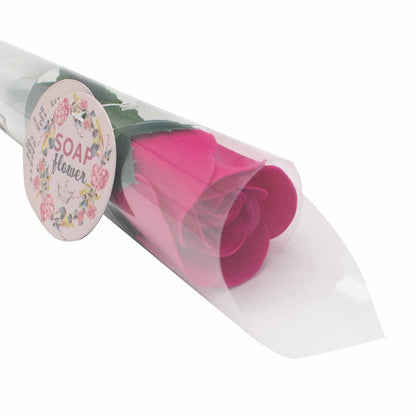 A small, realistic red soap rose presented on a stem in a plastic wrap.