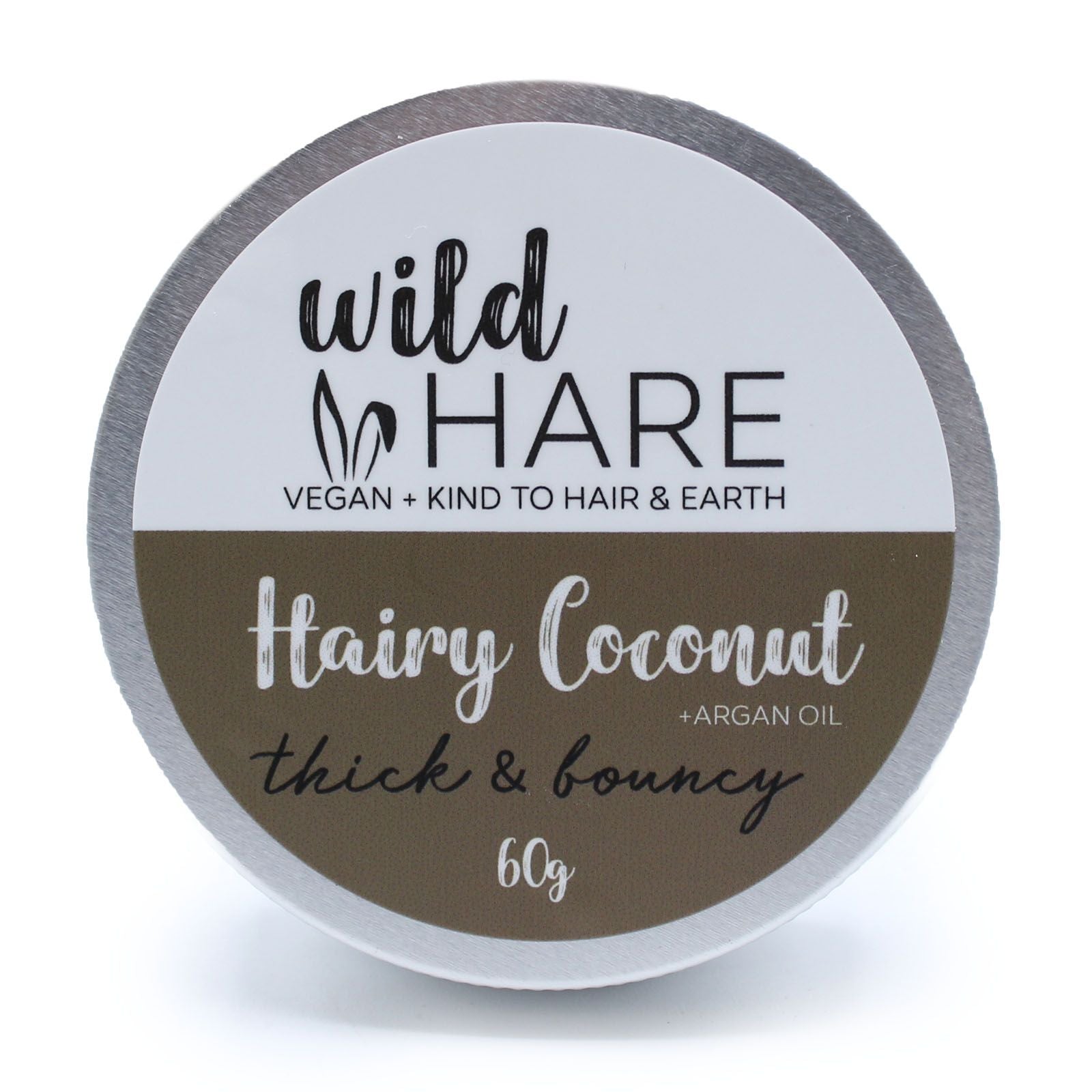 A 60g Wild Hare solid shampoo bar with a coconut scent, presented in a metal travel-friendly storage tin.