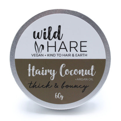 A 60g Wild Hare solid shampoo bar with a coconut scent, presented in a metal travel-friendly storage tin.