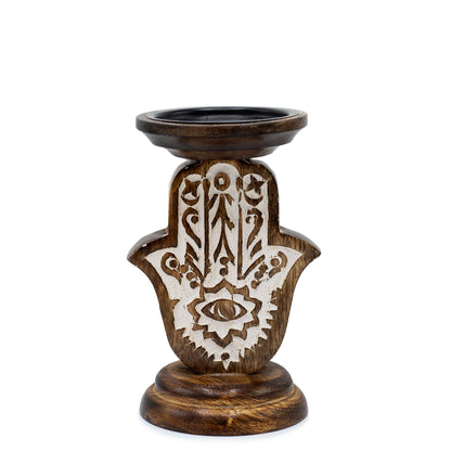 Hand-carved dark mango wood ritual candle tray in the shape of a Hamsa hand for spiritual home decor and altars.