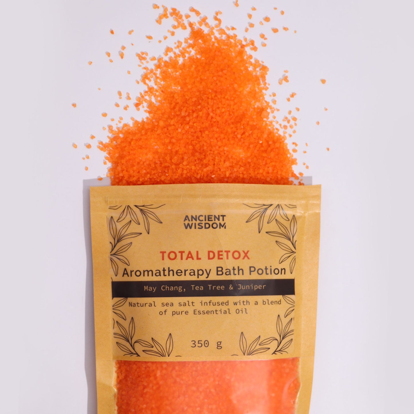 A kraft paper pouch overflowing with bright orange aromatherapy bath salts infused with purifying essential oils.