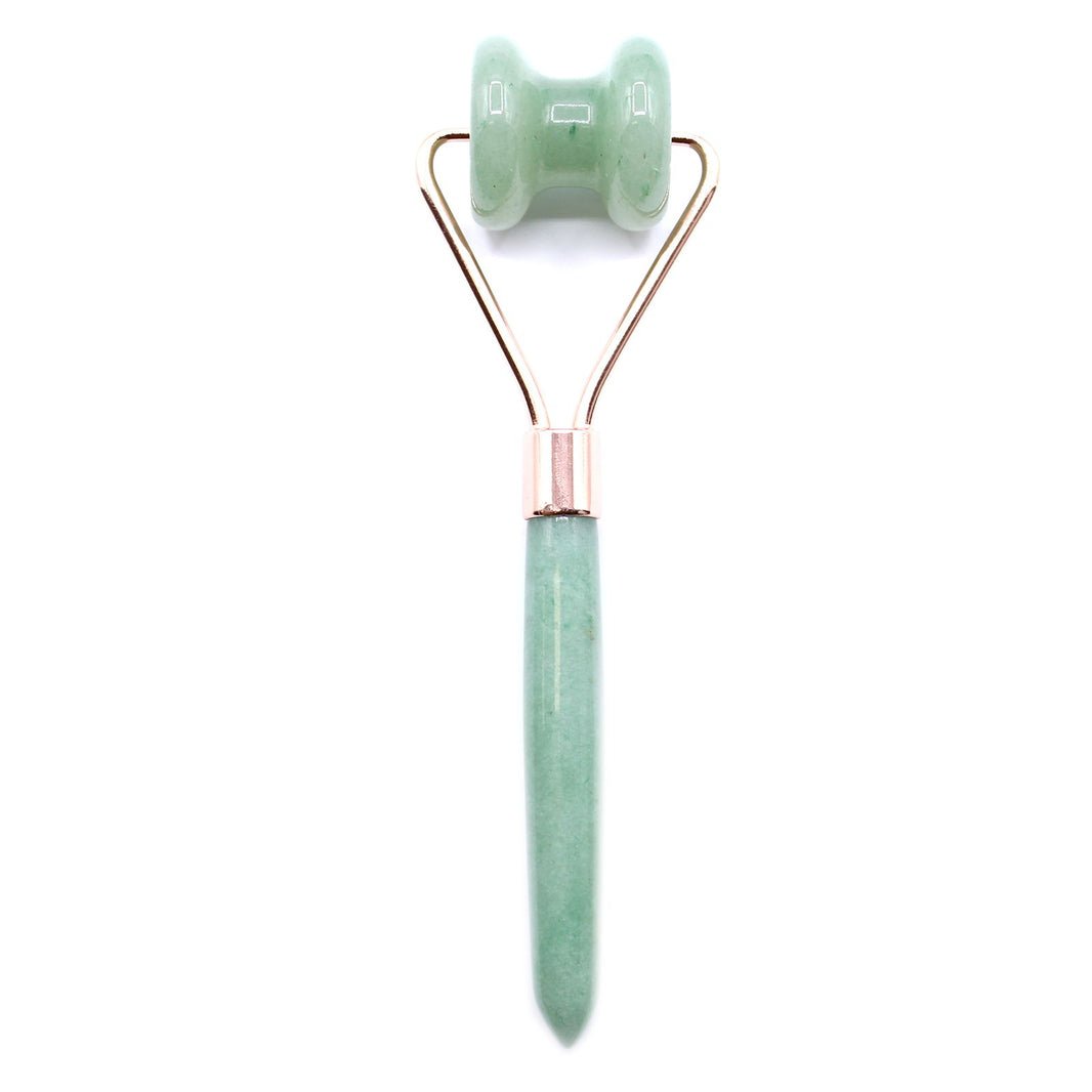 A luxury gemstone jawline roller made from natural green jade with a gold-tone handle for facial massage and sculpting.