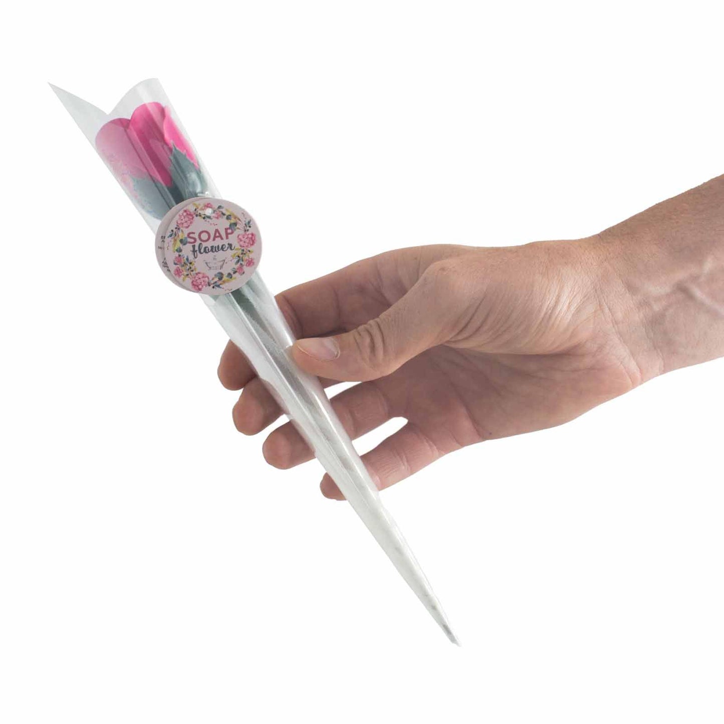 A small, realistic red soap rose presented on a stem in a plastic wrap.