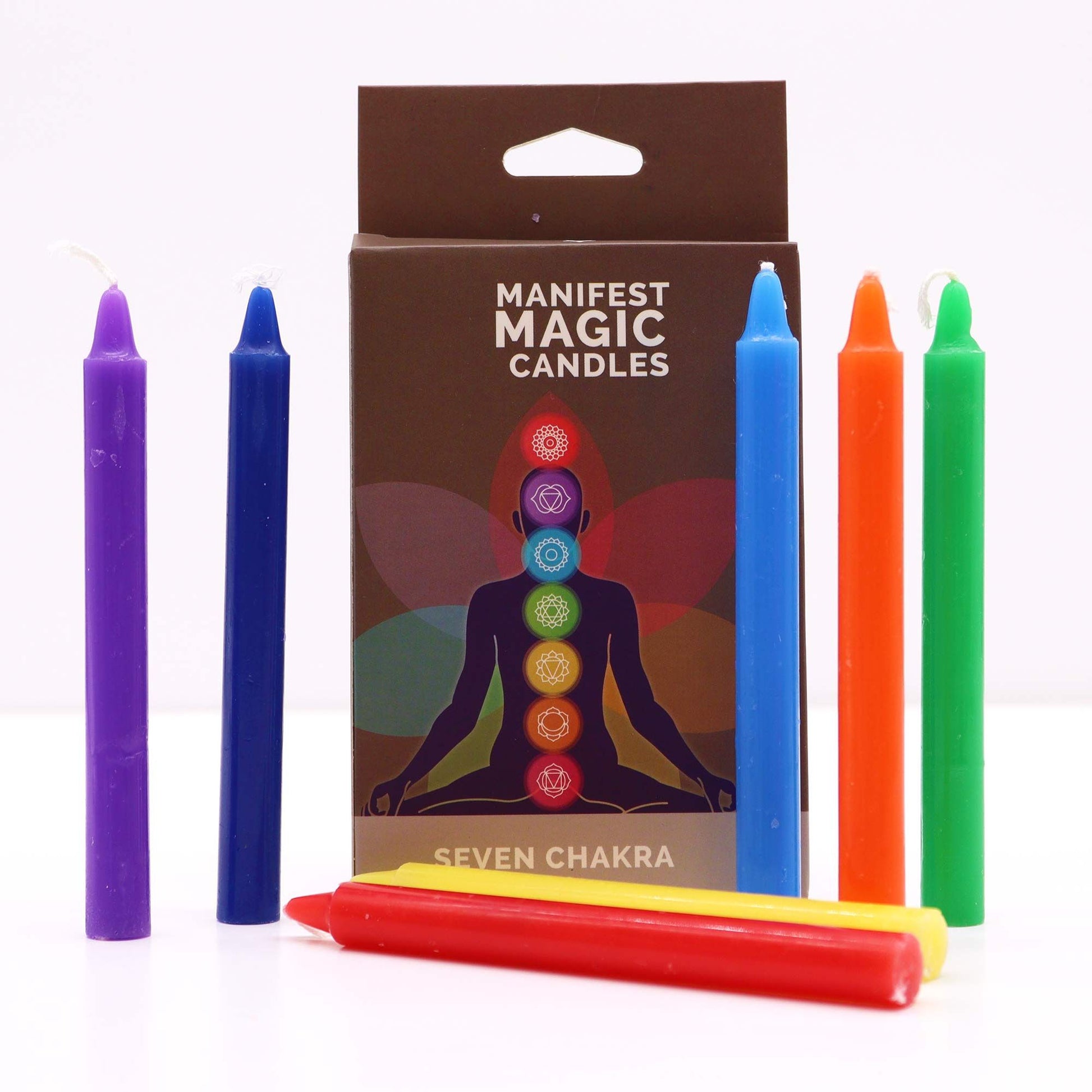 A slim gift box containing seven individual ritual candles in vibrant rainbow colors, labeled for each chakra energy center.