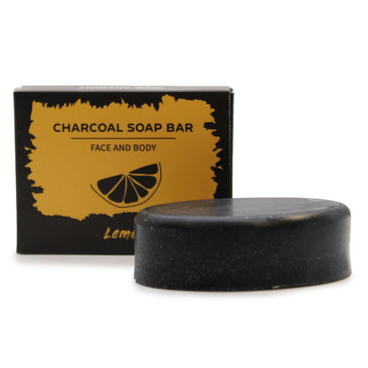 A charcoal-black soap bar presented in an elegant black box featuring vibrant yellow lemon citrus designs.