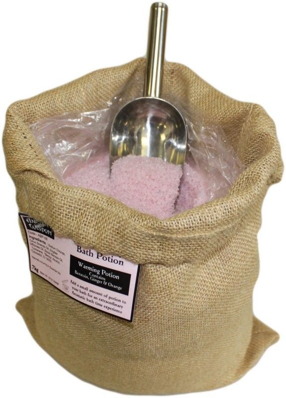 A large 7kg rustic hessian sack filled with Warming Potion bath salts, featuring a traditional apothecary scoop.