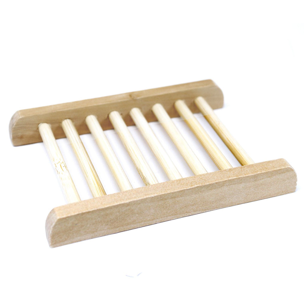 A light-colored natural Hemu wood soap dish in a ladder-style design with thin slats for efficient drainage.