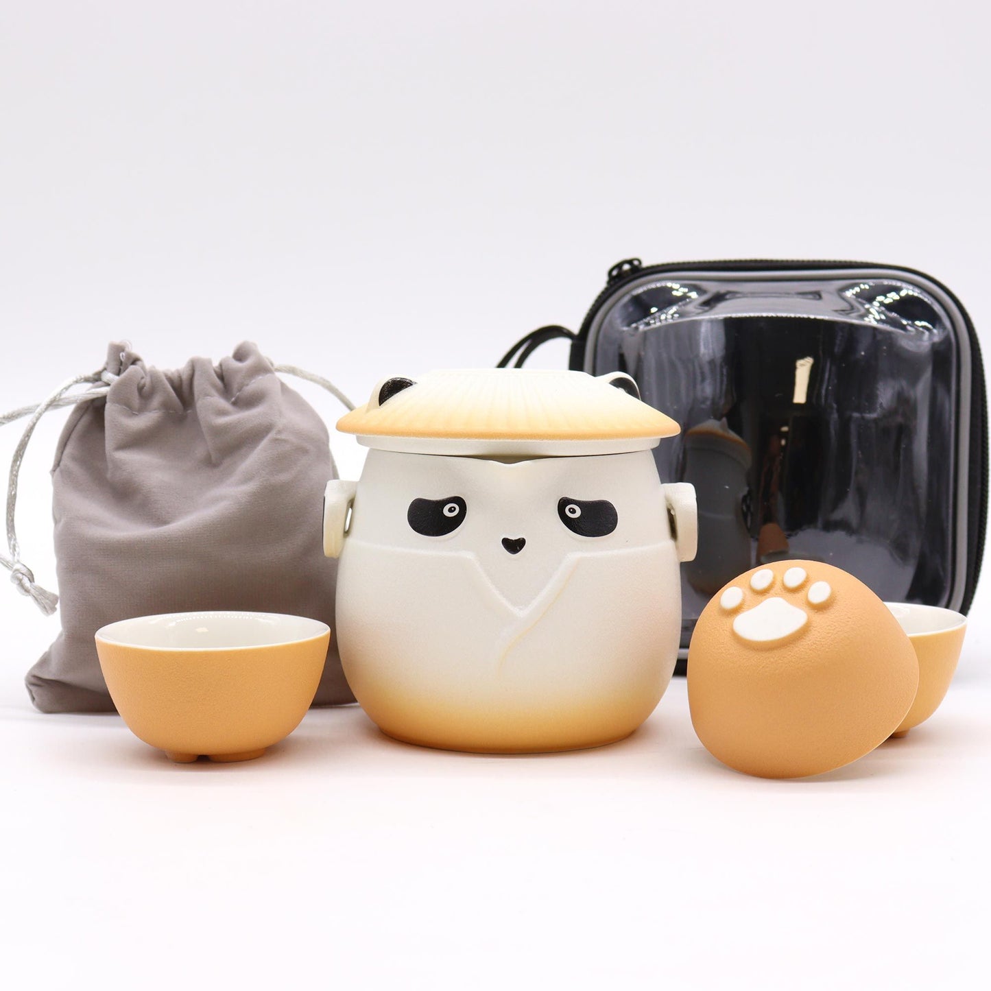 A vibrant orange and white ceramic teapot decorated with panda motifs and three coordinating small handleless cups.