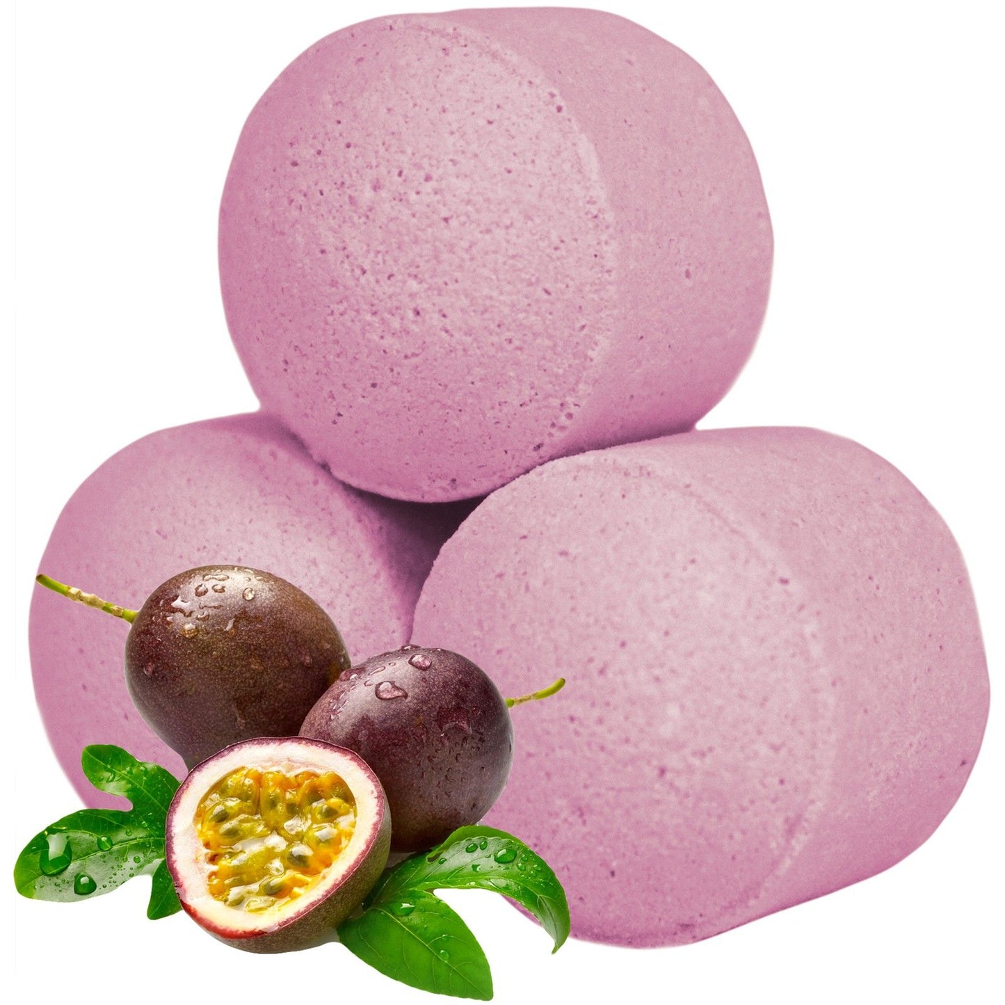 A bulk box overflowing with vibrant pink, passion fruit-scented mini bath bombs, styled with fresh tropical fruit.