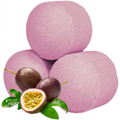 A bulk box overflowing with vibrant pink, passion fruit-scented mini bath bombs, styled with fresh tropical fruit.
