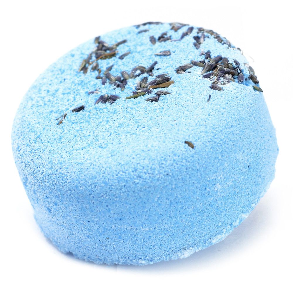 A vibrant blue spherical bath bomb decorated with a crown of dark purple dried botanical elements.
