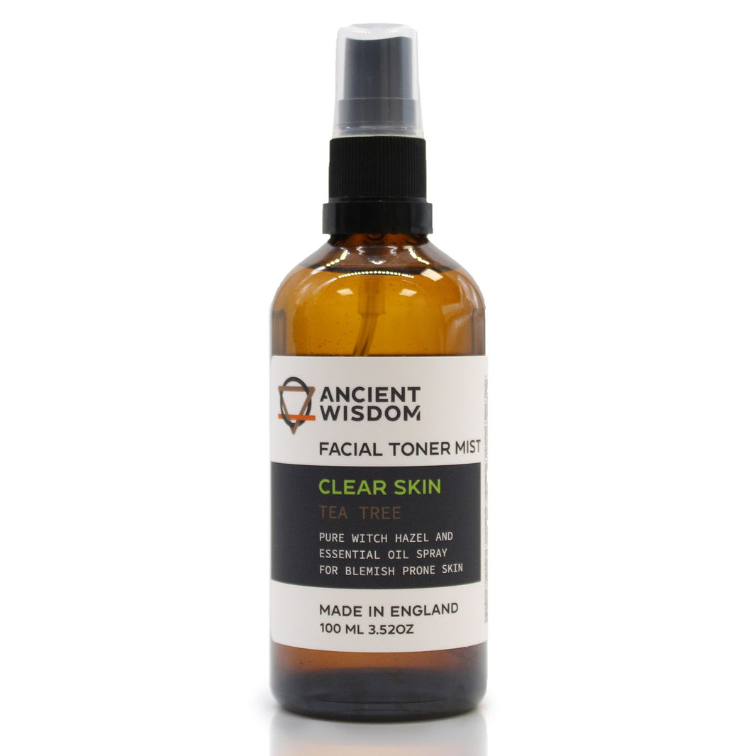 A 100ml amber spray bottle of Witch Hazel and Tea Tree toner with a white and gold apothecary-style label.